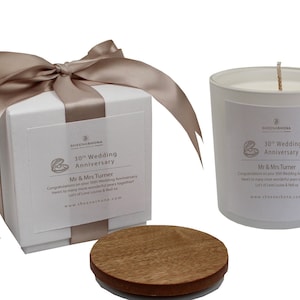 May include: A white candle with a wooden lid in a white box with a beige ribbon. The candle and box have a label that says "30th Wedding Anniversary" and "Mr & Mrs Turner".