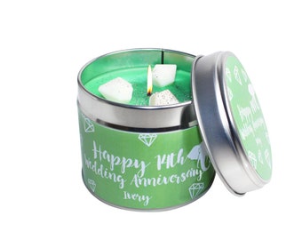 May include: A green candle in a tin container with a lid. The candle has a white label that says "Happy 14th Wedding Anniversary Ivory".