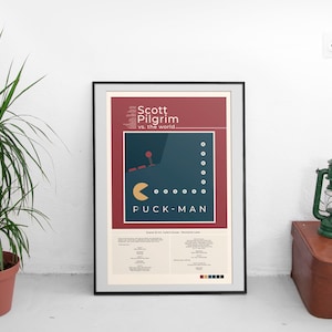 May include: A poster with a red background and a blue Pac-Man graphic. The text on the poster reads "Scott Pilgrim vs. the world" and "Puck-Man".