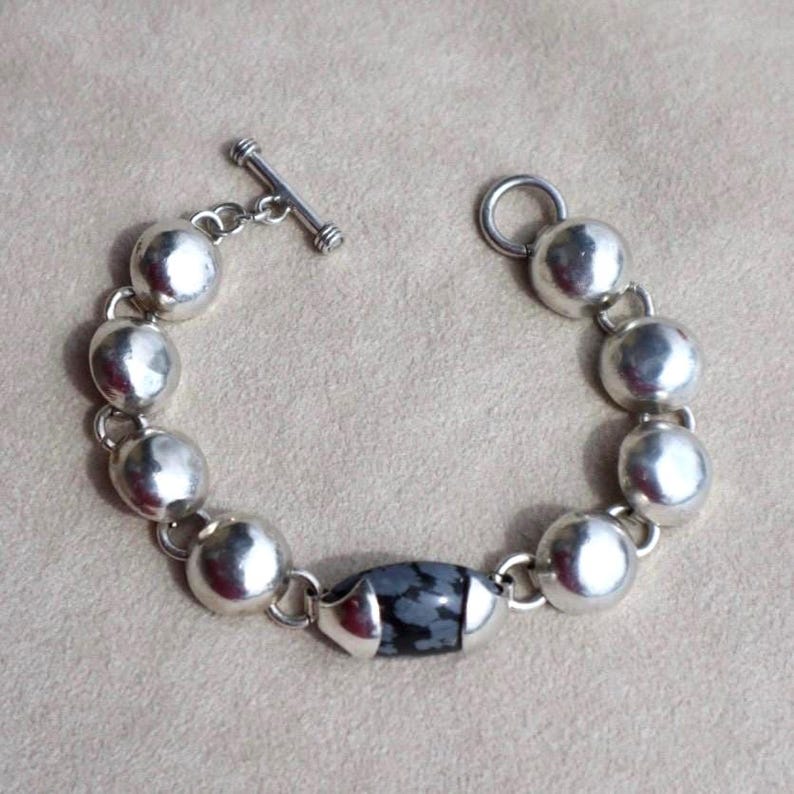 Mexican Silver Bracelet Taxco Sterling Jewelry Handcrafted Design Modernist Style Vintage Piece Collectible Treasure Snowflake Jasper Stone Black Gemstone Setting Toggle Clasp Feature Artisan Made Jewelry Statement Accessory Elegant Gift