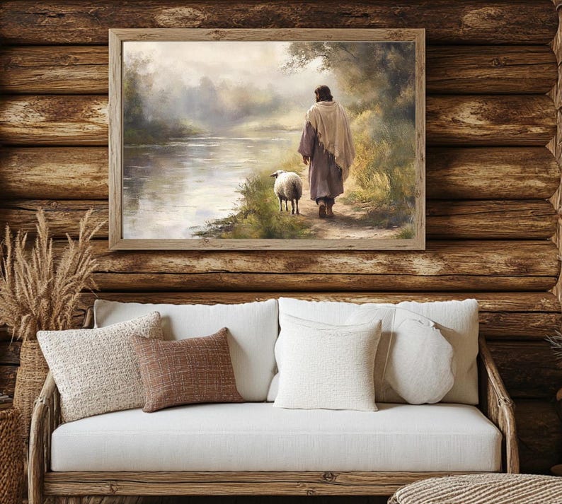 May include: A painting of a man in a robe walking with a sheep along a river. The painting is framed in a wooden frame and is set against a wooden wall.
