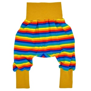 May include: Rainbow striped baby pants with yellow elastic waistband and cuffs.