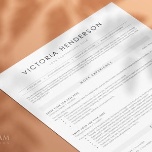 May include: A black and white resume template with the title "Victoria Henderson" at the top. The resume includes sections for work experience, education, and skills.