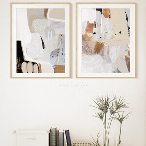 May include: Two abstract paintings in beige, brown, and black frames. The paintings are in a minimalist style with abstract shapes and lines. The text "INSPIRATION ABSTRACTS" is below the paintings.