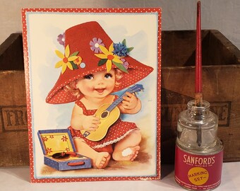 Sweet Vintage 7.5"x9.5" Oversized Unused Greeting Card ~ Baby wearing a red polka dot dress and hat playing a toy guitar - 1960s