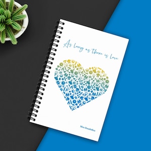 May include: A white spiral-bound notebook with the text "As long as there is love" in teal script. A heart-shaped design filled with small icons in shades of blue and yellow is centered on the cover. The name "Mrs Doubtfire" is printed at the bottom.