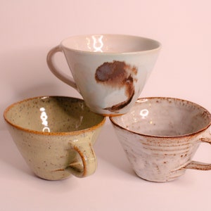A Collection Of Espresso Cups Designed With Unique Decorative Swirls