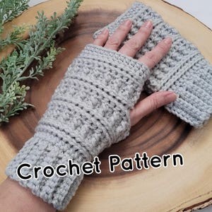 May include: A pair of grey crocheted fingerless gloves with a "Crochet Pattern" text overlay.