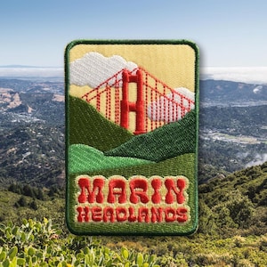 May include: A yellow, green, and red embroidered patch with a depiction of the Golden Gate Bridge and the text "Marin Headlands".