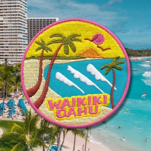 May include: Embroidered patch with a tropical theme. The round patch features palm trees, ocean waves, and the text "WAIKIKI OAHU" in a colorful design. The patch has a yellow background with a pink border.