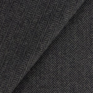 May include: Close-up of a dark gray herringbone fabric. The fabric has a subtle texture and a woven pattern.