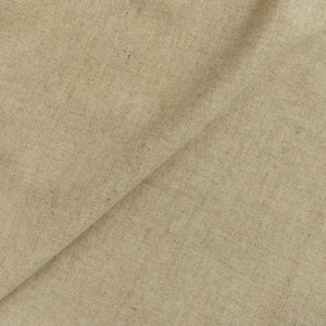 May include: A close-up of a beige fabric with a slightly textured surface.