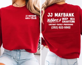 May include: Red sweatshirt with white text that reads "JJ Maybank Kildare Island Deep Sea Charters Live Bait Tackle Provisions (252) 522-5502"