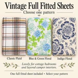 May include: Three folded full fitted sheets with distinct patterns. The left sheet features a white, black, and tan plaid design. The center sheet has a white background with blue and green floral motifs. The right sheet displays a cream background with dark blue floral patterns. Text reads: Vintage Full Fitted Sheets, Choose one pattern, Classic Plaid, Blue & Green Floral, Indigo Floral, Lovely for cottage bedrooms and layered camper interiors. One full fitted sheet included • Select your pattern.