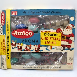 May include: Vintage Amico by NOMA Christmas lights in original box. The box is blue and yellow with Santa Claus illustrations and text that reads "15-Outdoor Christmas Lights". The lights are visible through the clear plastic.