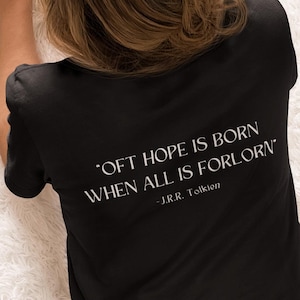 May include: A black t-shirt with the quote "Oft hope is born when all is forlorn" by J.R.R. Tolkien printed on the back.