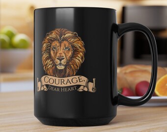 May include: Black coffee mug with a lion head graphic and the text "Courage, Dear Heart".