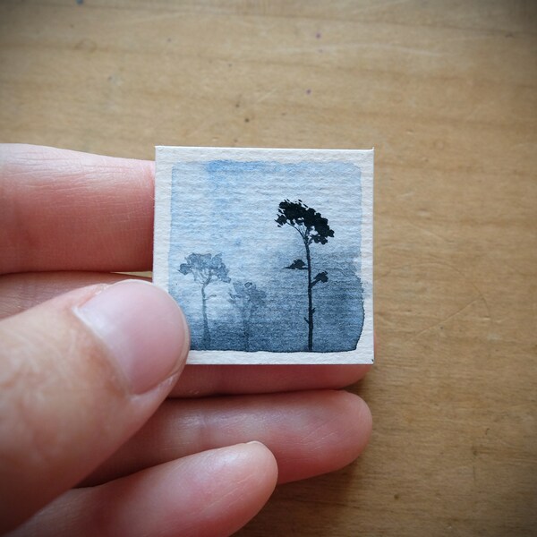 Tiny winter Landscape with 3 trees in blue mist