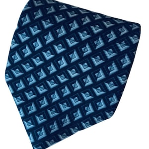 May include: A dark blue necktie with a geometric pattern of light blue squares.