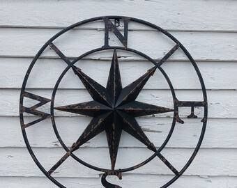 Metal Compass With Black Rusted Details. 24 inches wide by 24 inches tall.