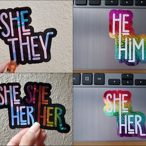 May include: Four different pronoun stickers with a rainbow glitter background. The stickers say "She They", "He Him", "She Her", and "She She Her Her".