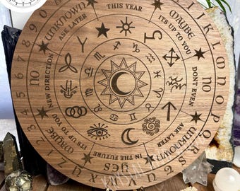May include: A circular 40cm walnut wood board featuring laser-engraved letters A through Z, numbers 0 through 9, zodiac symbols, and phrases including yes, no, maybe, unknown, ask later, this year, and in the future, with a central sun and moon.