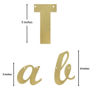 May include: Gold glitter letter banner that spells "table" with each letter measuring 5 inches tall and 8 inches wide.
