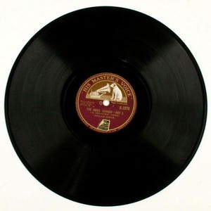 May include: A black vinyl record with a red and gold label. The label features the text "HIS MASTER'S VOICE" and a drawing of a dog listening to a gramophone. The record is labeled "THE ANVIL CHORUS - ACT 2".
