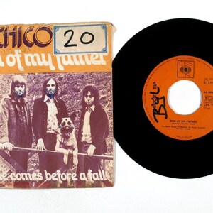 May include: Vintage vinyl record and sleeve for "Son of My Father" by Chico. The sleeve features a band photo and the phrase "pride comes before a fall." The record label is orange with black text. The record is black.