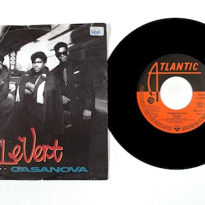 May include: A LeVert "Casanova" vinyl record and album cover. The album cover features three men in suits, with the band's name in red and the album title in blue. The record label is Atlantic, with orange and white text.