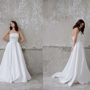 Simple satin wedding dress Corset bodice Long skirt with pleats pockets and train A line Strapless Clean modern Plain bridal gown Elegant