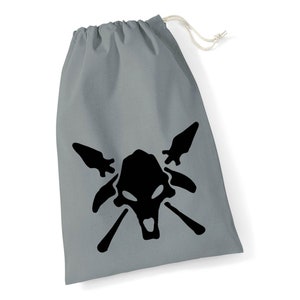 May include: Grey drawstring bag with a black skull and crossbones design. The skull has two large eyes and a wide open mouth.