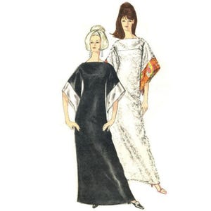 May include: Two women wearing long evening gowns. The woman on the left is wearing a black gown with white trim on the sleeves. The woman on the right is wearing a white gown with a colorful scarf draped over her shoulders.