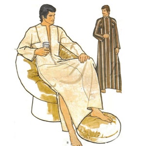 May include: Two men wearing long robes. The man on the left is sitting in a chair and holding a glass. The man on the right is standing and wearing a striped robe.