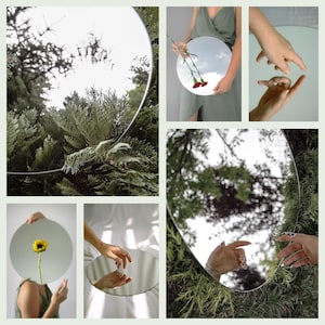 May include: A collection of round mirrors reflecting different scenes, including a sunflower, a hand, and a view of the sky through trees.