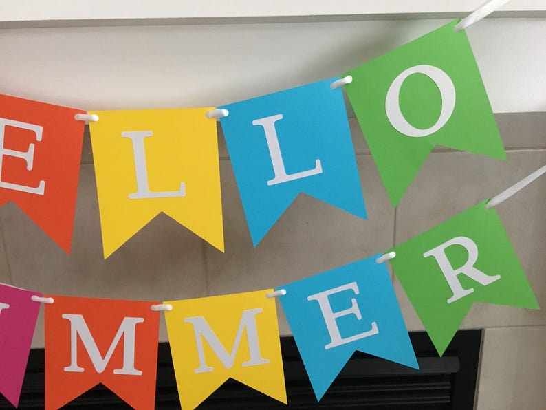 May include: A colorful banner with the words "HELLO SUMMER" in white letters on a rainbow of colored flags.