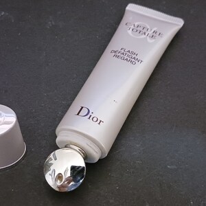 May include: A white tube of Dior Capture Totale Flash D&eacute;fatigant Regard eye cream with a silver rollerball applicator. The tube has the Dior logo and the product name printed on it.