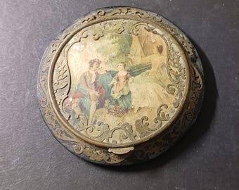 Antique celluloid and brass compact. Mother, Father and child scene. Very old and not to bad of shape. From the late 1800's to early 1900,s