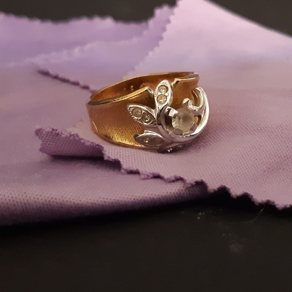 Vintage 18k HGE, gold tone, size 7 ring with rhinestones. Very nice. Has a logo inside, but can't make it out. Fast, free shipping to U.S.A.