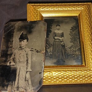 May include: Two antique tintype photographs in ornate gold frames. The left image shows a young person wearing a hat and a patterned dress. The right image shows a woman in a plaid dress standing in a garden.