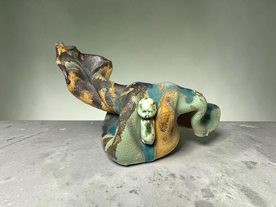 A studio-thrown abstract serpentine ceramic sculpture that feels like something you'd find in a contemporary art gallery, not on Amazon — genuinely sculptural and strange.