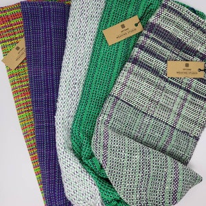 May include: Five woven fabric bags in various colors and patterns. The bags are made with a woven technique and have a drawstring closure. The bags are labeled with "Options Weaving Studio".