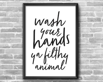 May include: Black and white framed print with the text "wash your hands ya filthy animal!" on a white background.