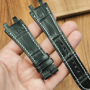 May include: Black leather watch strap with white stitching. The strap has a crocodile pattern and is designed for a watch with a lug width of 22mm.