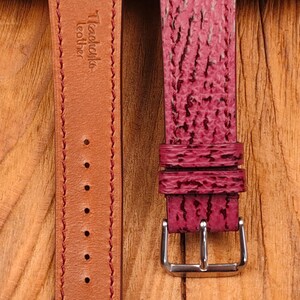 May include: Two-piece watch strap in a deep burgundy color. The strap features a textured surface and a contrasting tan leather backing. The buckle is silver-toned. The brand name "Tkachenko leather" is visible on the strap.