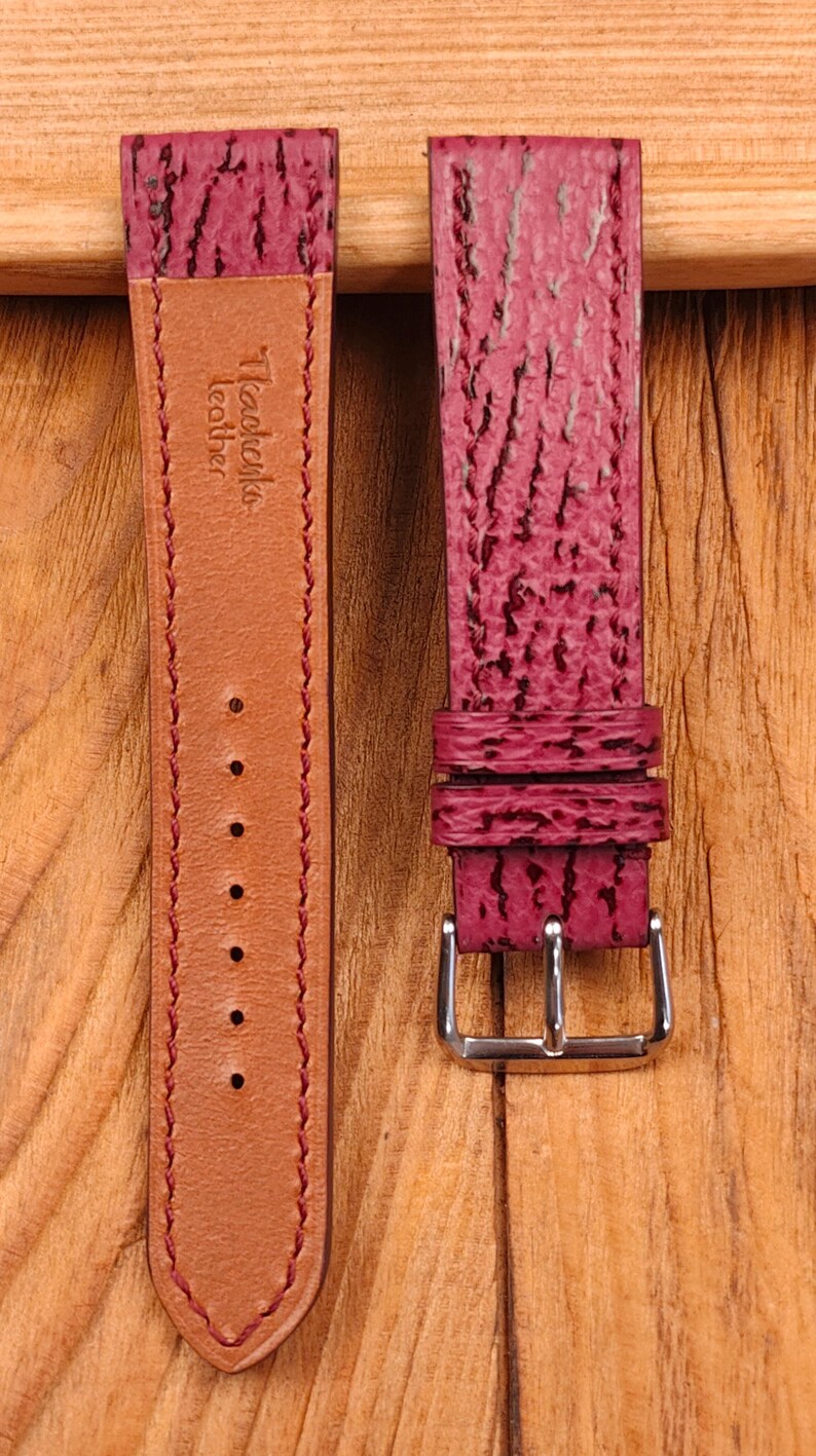 May include: Two-piece watch strap in a deep burgundy color. The strap features a textured surface and a contrasting tan leather backing. The buckle is silver-toned. The brand name "Tkachenko leather" is visible on the strap.