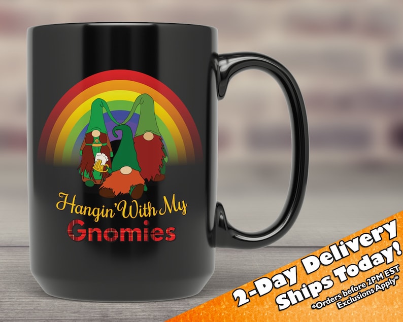May include: Black ceramic coffee mug featuring a rainbow and three gnomes holding beer mugs. The text "Hangin' With My Gnomies" is printed on the mug.