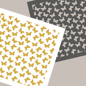 May include: Two sheets of paper with a pattern of gold and gray butterflies. The text "Joyous Times" is printed at the bottom of the image.