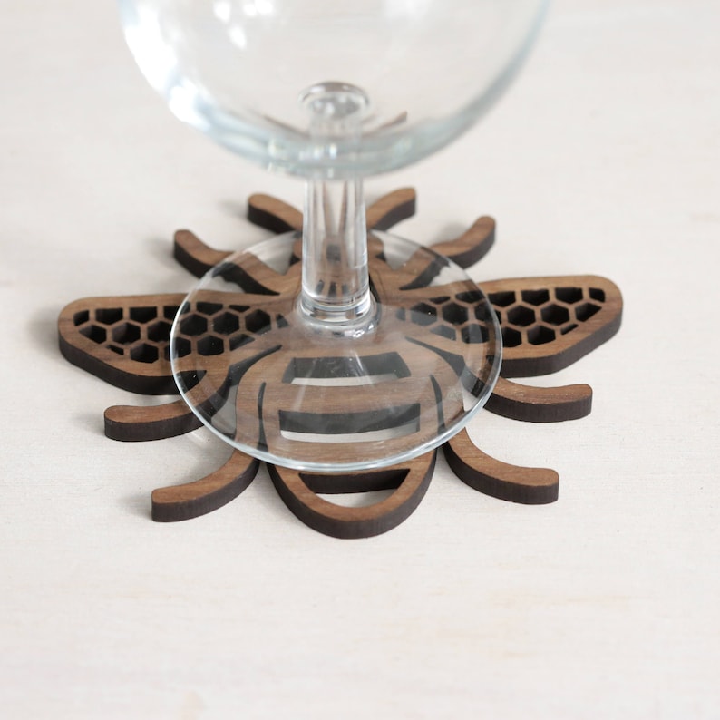 Manchester Bee Coaster under a wine glass
