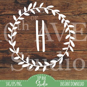 May include: White monogram letter H with a wreath of leaves around it. The text "Property of" is above the letter and "10th Ave Studio" is below the wreath. The background is a wood grain pattern.
